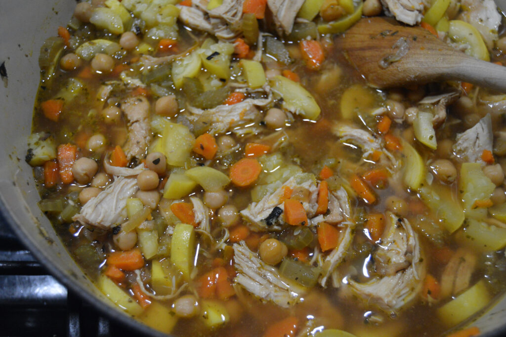 Lemon chicken soup with yellow squash and chickpeas.