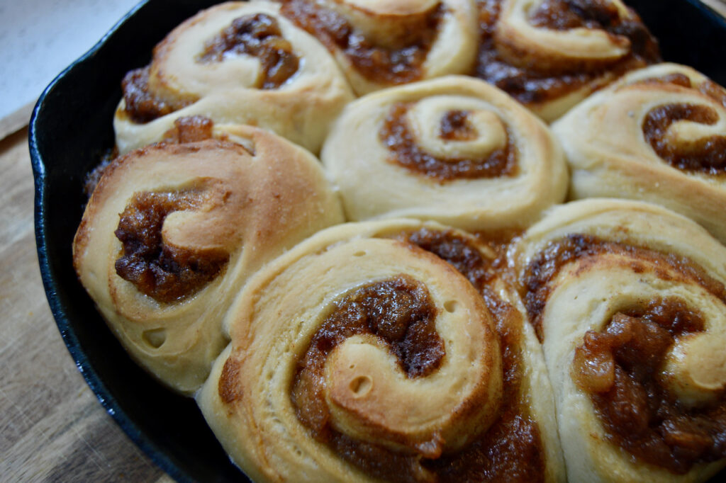 Pear Butter Sourdough Cinnamon Rolls golden brown after baking in the oven.