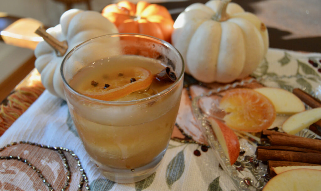 Garnishing this apple cider cocktail with a candied orange slices with cloves inserted into slice for additional flavor and visual appeal. 