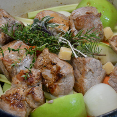 Searing pork tenderloin on a bed of carrots, celery, onions, and apples creates a sweet and savory Braised Spiced Cider Pork Tenderloin.