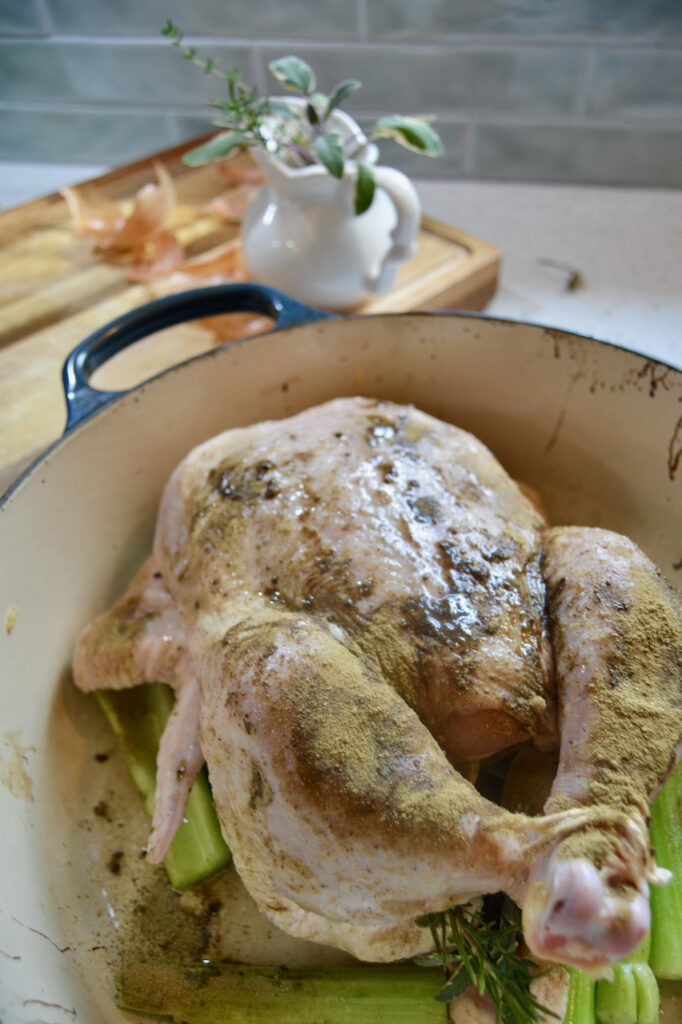 Truss the whole chicken, tying the legs together with twine to keep the chicken moist during baking.