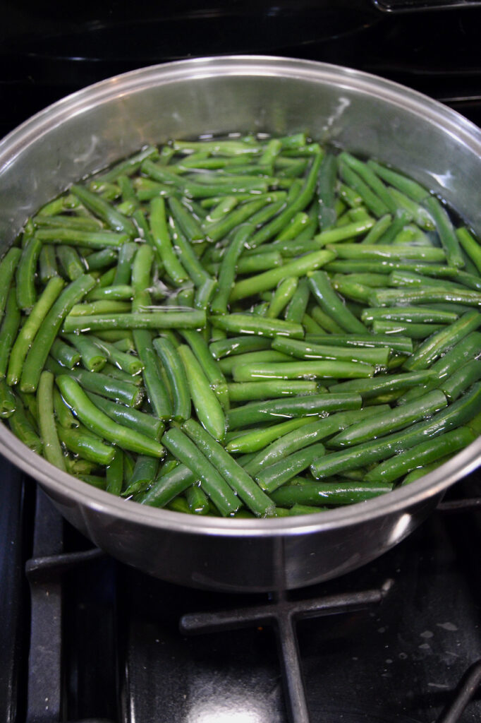 Boil fresh green beans to make a healthier version of traditional green bean casserole.