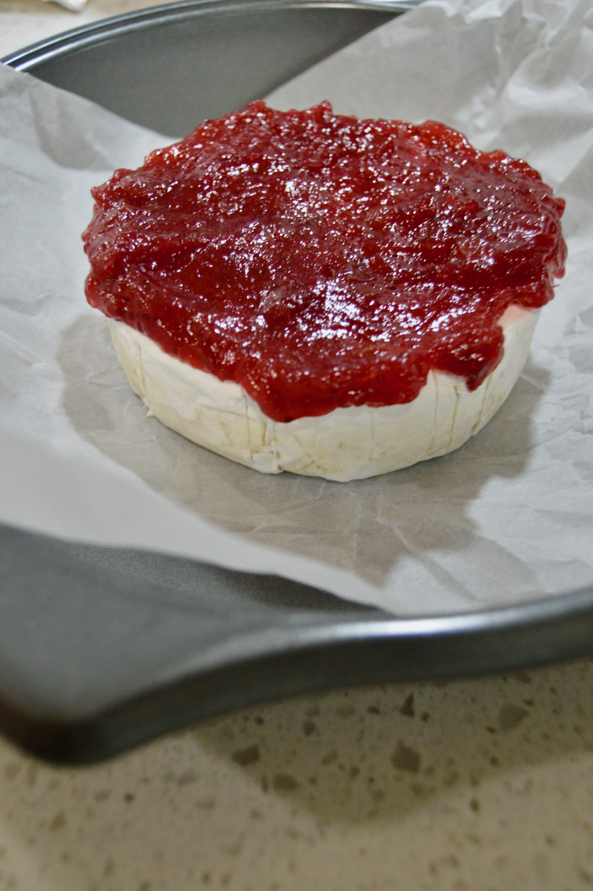 Creamy brie topped with cranberry sauce for an easy and beautiful Thanksgiving side.