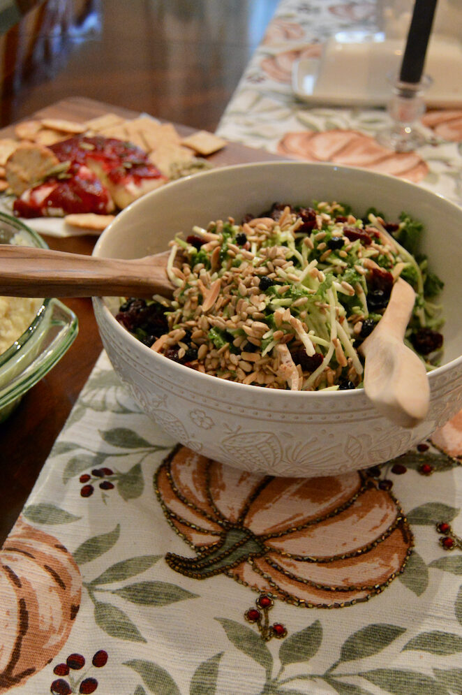 Thanksgiving side salad beautifully arranged in a bowl sporting a fall-themed print.