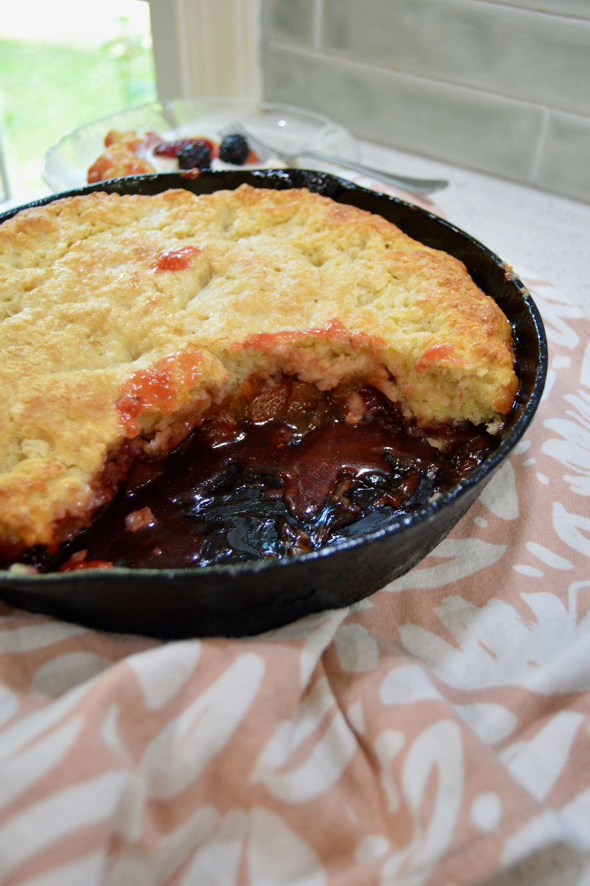 Rhubarb berry compote filling with a thick, flaky biscuit topping in this recipe